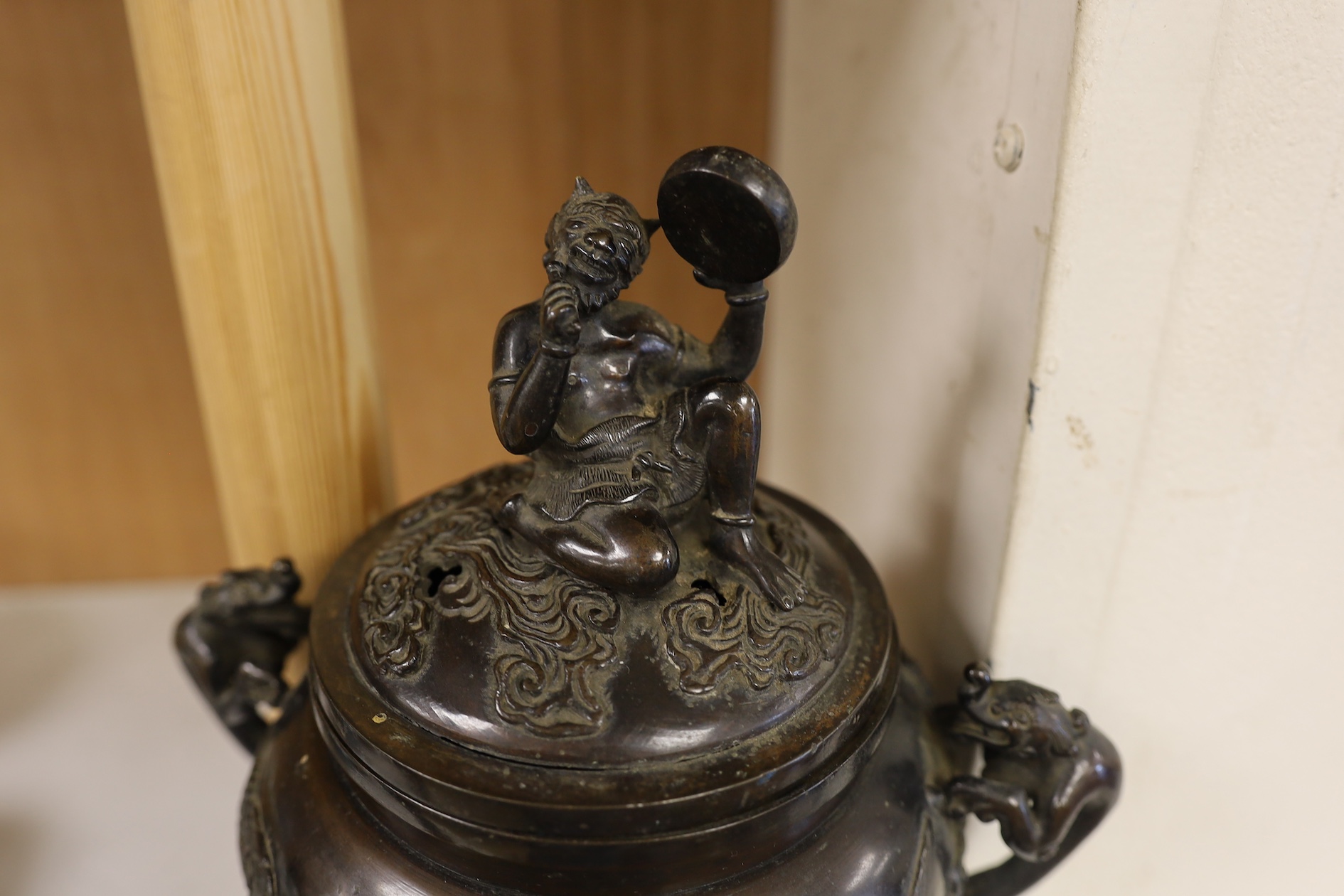 A Japanese bronze dragon handled censer with figural finial to cover, Meiji period, 24cm high. Condition - good